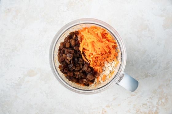 Shredded carrots, raisins and rolled oats added to the blended ingredients for the oatmeal carrot cake.