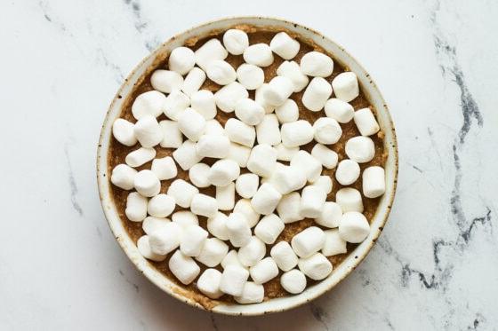 Πιάτο με σοκολατένιο s'mores dip ρεβιθιών με μίνι μαρσμέλοου πριν το ψήσιμο.