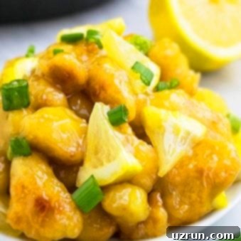 Best Easy Chinese Lemon Chicken on White Dish With Marble Background.