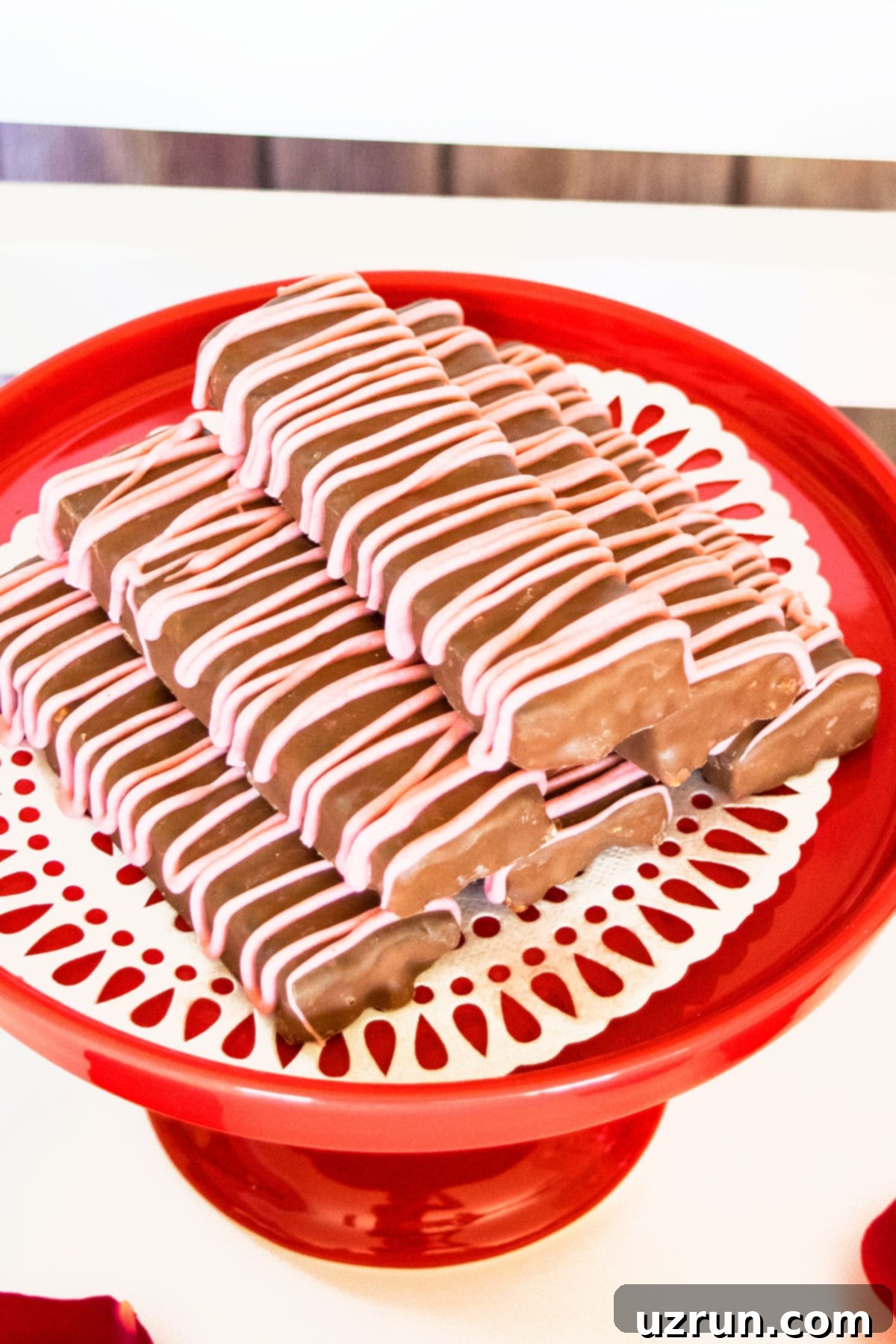 Delicious Food and Romantic Decor for Your Valentine's Day Party 11 Chocolate Covered Granola Bars on Red Cake Stand.
