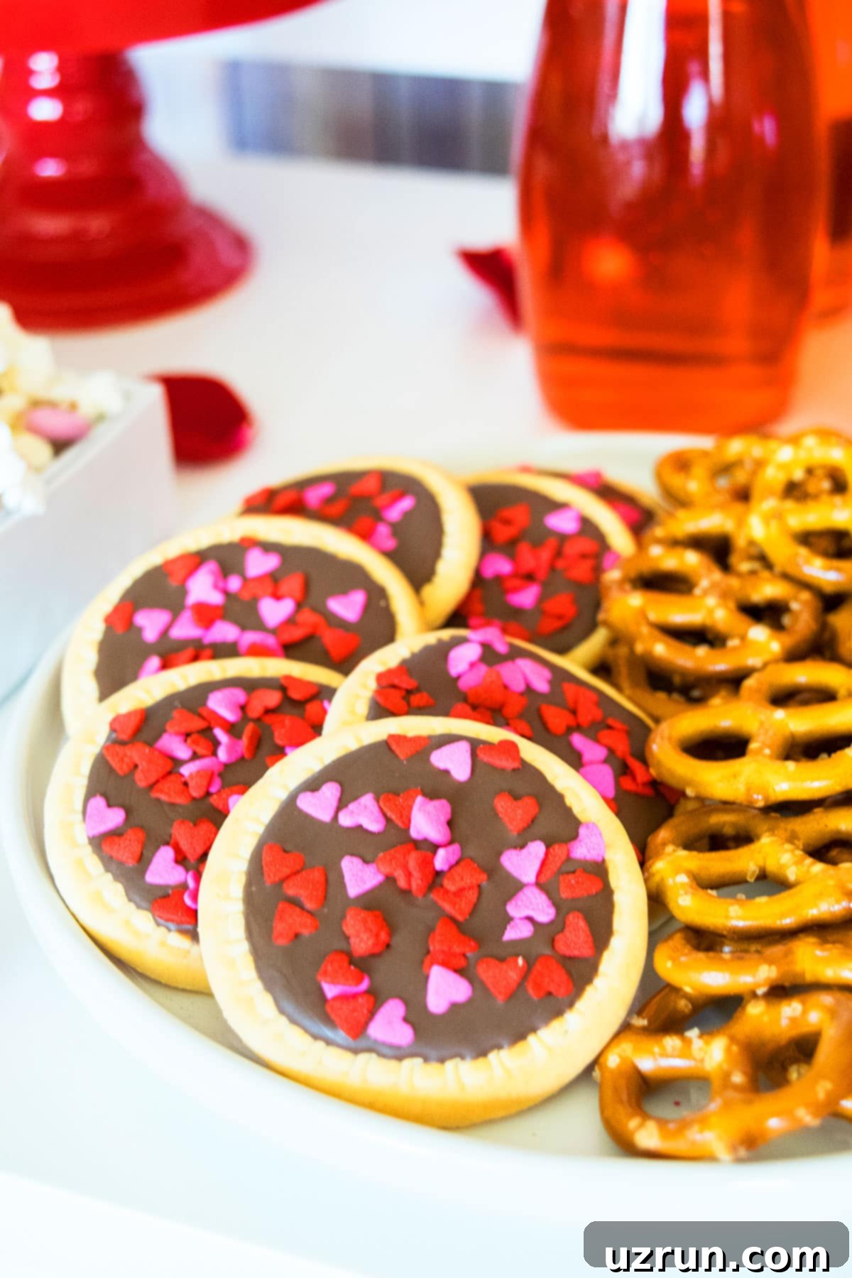 Delicious Food and Romantic Decor for Your Valentine's Day Party 6 Round Sugar Cookies With Chocolate and Heart Sprinkles.