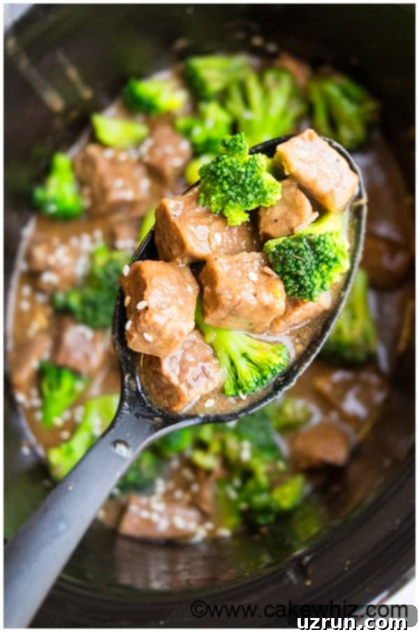 Effortless Slow Cooker Beef & Broccoli 3 Close up of tender slow cooker beef and broccoli in a serving bowl, showcasing the rich sauce and perfectly cooked ingredients.