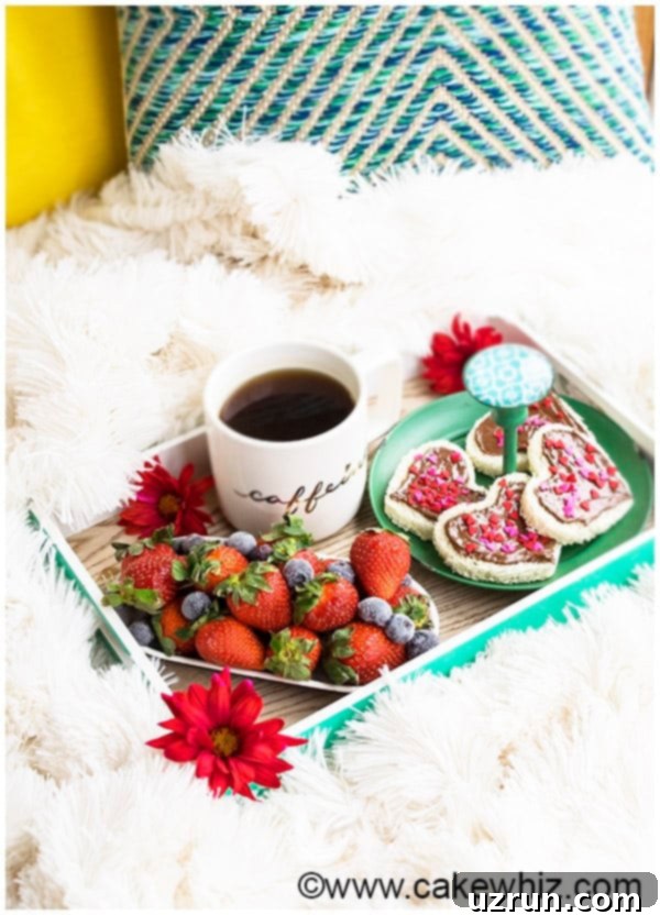 Easy Breakfast in Bed Recipes 4 Bright and colorful Birthday Breakfast in Bed Tray with heart-shaped Nutella sandwiches, fresh berries, and vanilla cupcake swirl coffee.