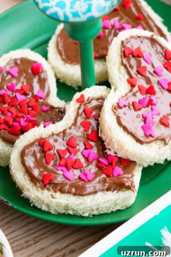 Easy Breakfast in Bed Recipes 7 Heart Nutella Sandwich with Sprinkles on a Green Dish - Open Faced