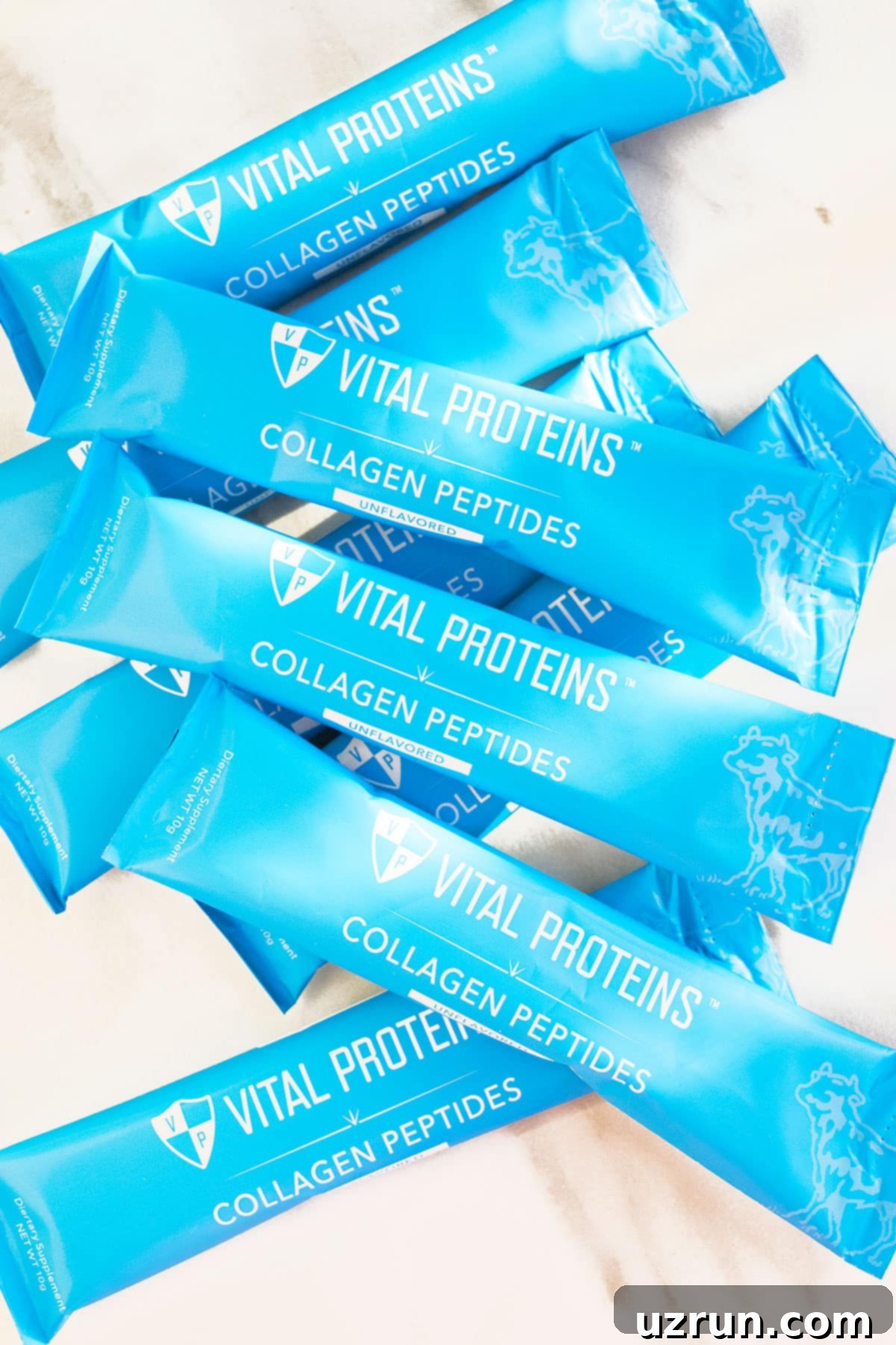 Chewy No-Bake Peanut Butter Oatmeal Bars 6 Packets of Vital Proteins Collagen Peptide Powder on White Marble Background. Emphasizing the sponsorship.