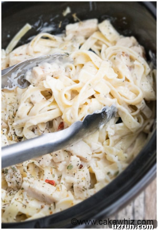 Slow Cooker Easy Chicken Alfredo Recipe with tender chicken and creamy sauce