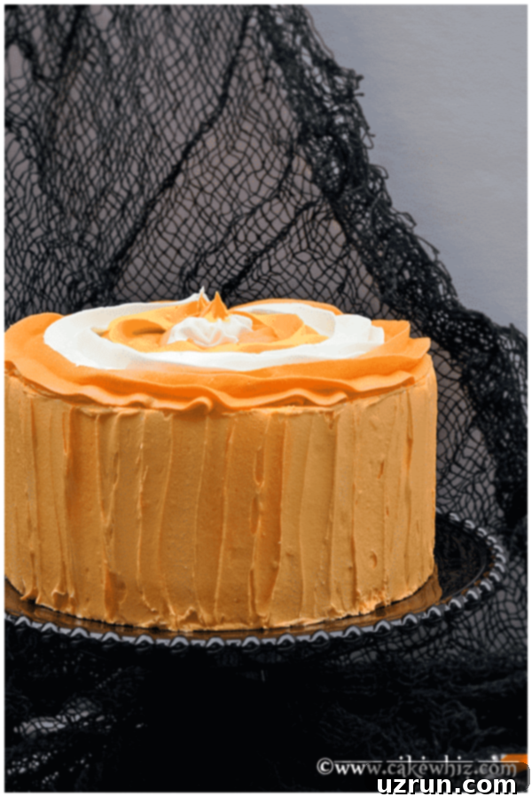 Halloween Cake Decorated With Orange, Yellow, White Buttercream Icing on Black Cake Stand