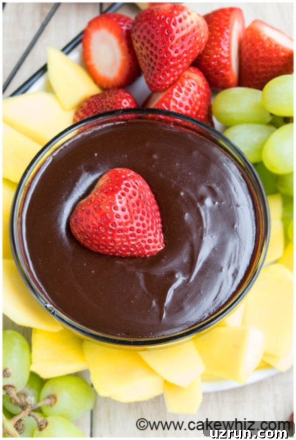 Easy Chocolate Fondue 3 Ingredients 5 Fondue Dip in Glass Bowl With Fruits-Overhead Shot.