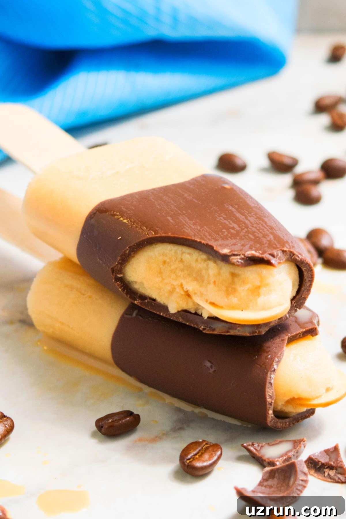 Iced Coffee Pops 5 Partially Eaten Popsicles on Marble Background With Coffee Beans.