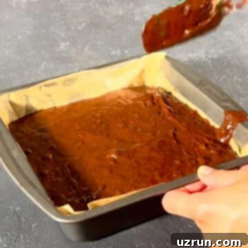 Mocha Espresso Brownies 11 Brownie batter spread out in baking pan with a spatula.