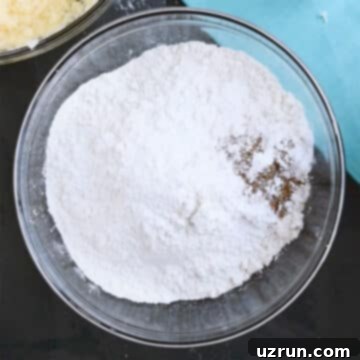 Perfectly Soft and Chewy Snickerdoodle Bars 6 Glass bowl with flour, spices and leavening agents.