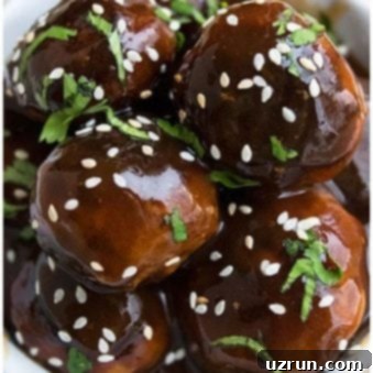 Sticky Korean BBQ Meatballs 6 Stack of Easy Sweet and Spicy Korean Meatballs in White Dish.