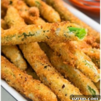 Perfectly Crisped Green Beans 5 Crispy Fried Green Beans in Small White Dish.