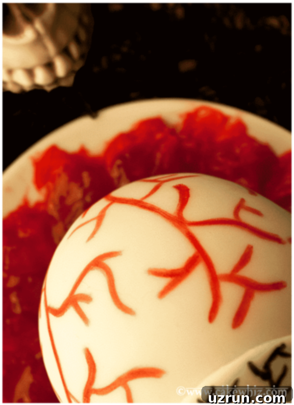 Spooky Easy Eyeball Cake Tutorial 3 Closeup Shot of Vein Decoration on Halloween Eyeball Cake