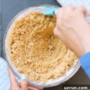 Easy Peanut Butter Blossoms with Hershey's Kisses 8 Cookie dough being mixed with spatula.