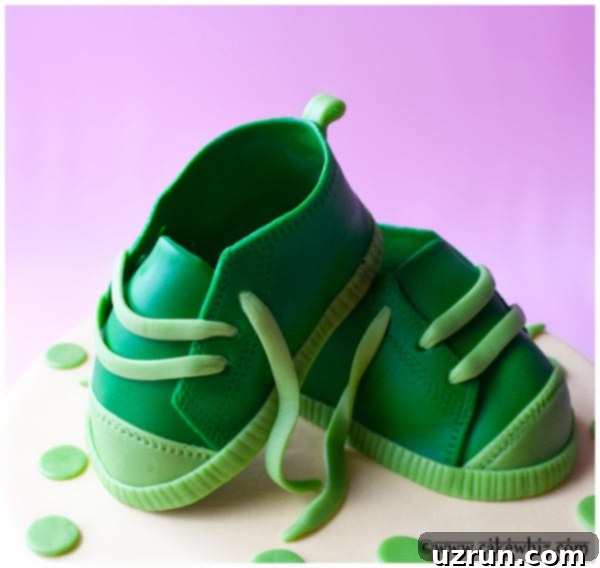 Easy Sneaker Cake 3 Closeup of meticulously crafted fondant baby shoes, resembling Converse sneakers, on a cake