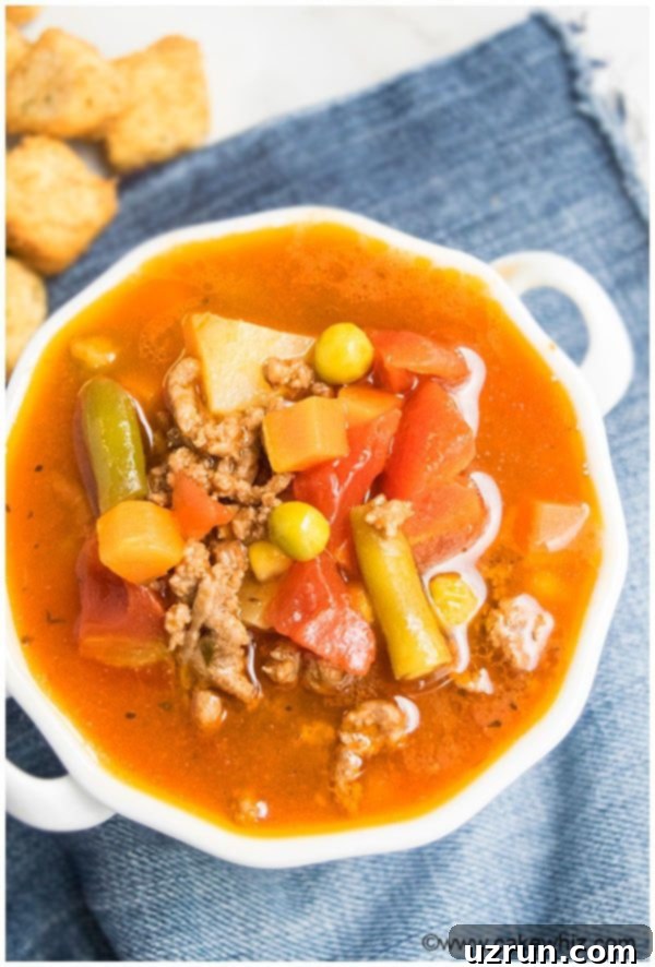 Homestyle Hamburger Soup 4 Easy Homemade Hamburger Soup in White Bowl, garnished with parsley.