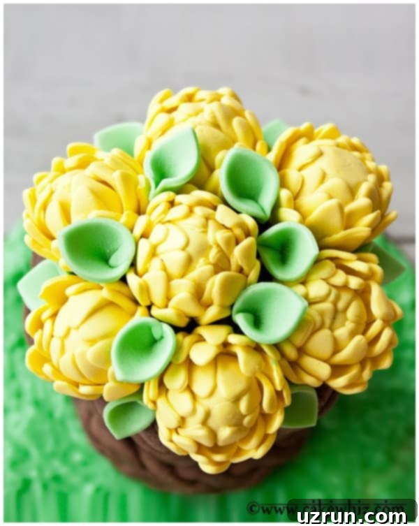 Floral Basketweave Cake 4 Overhead Shot of Yellow Fondant Flowers With Green and Gray Background