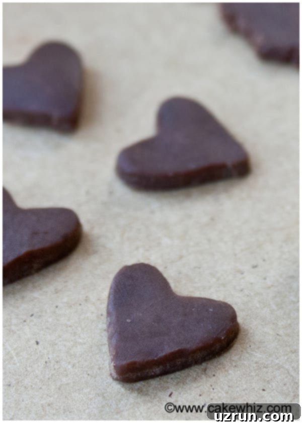 How to Make Modeling Chocolate 3 Homemade Candy Clay Hearts on Wood Background