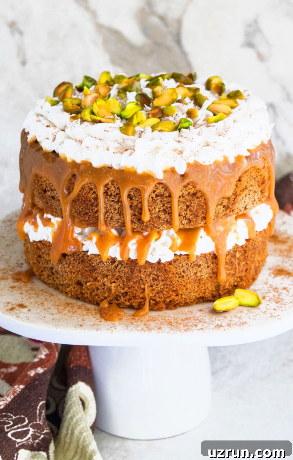 Easy Spice Cake (Chai Cake) on White Cake Stand and Marble Background. 