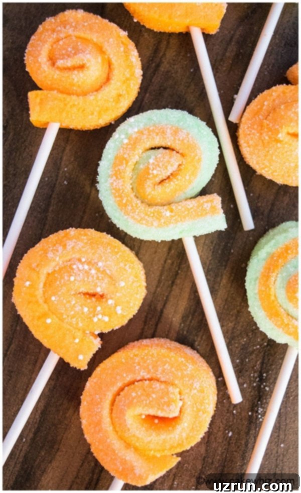 Orange and Green Jello Marshmallow Pinwheels on Wood Background. 