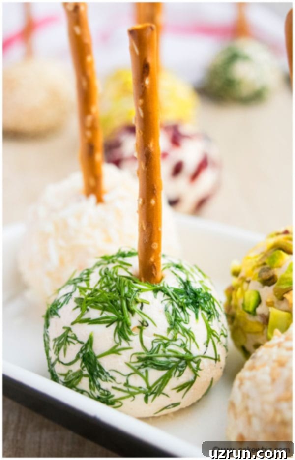 Mini Cheese Ball Covered in Fresh Dill on White Tray.