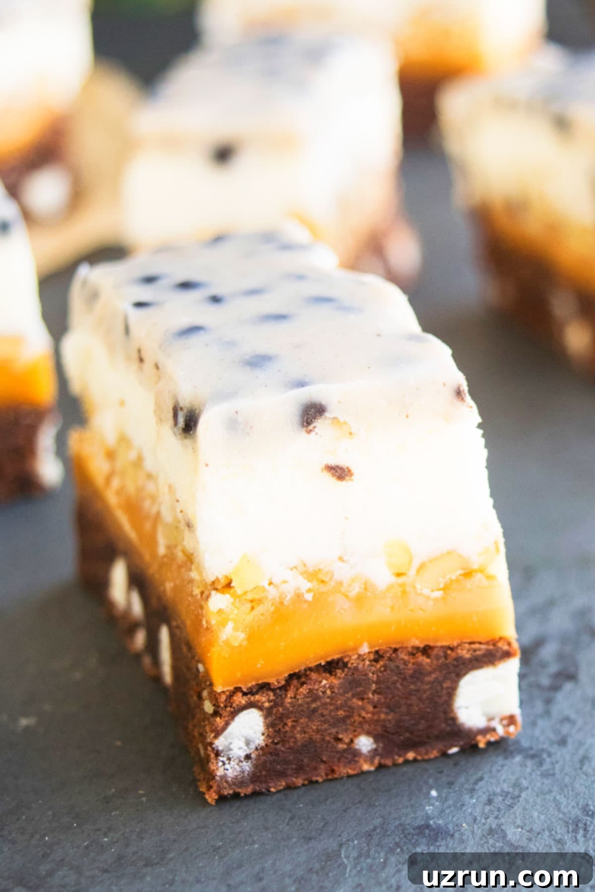 Slices of Chocolate Cookie Bars on Black Stone Background. 