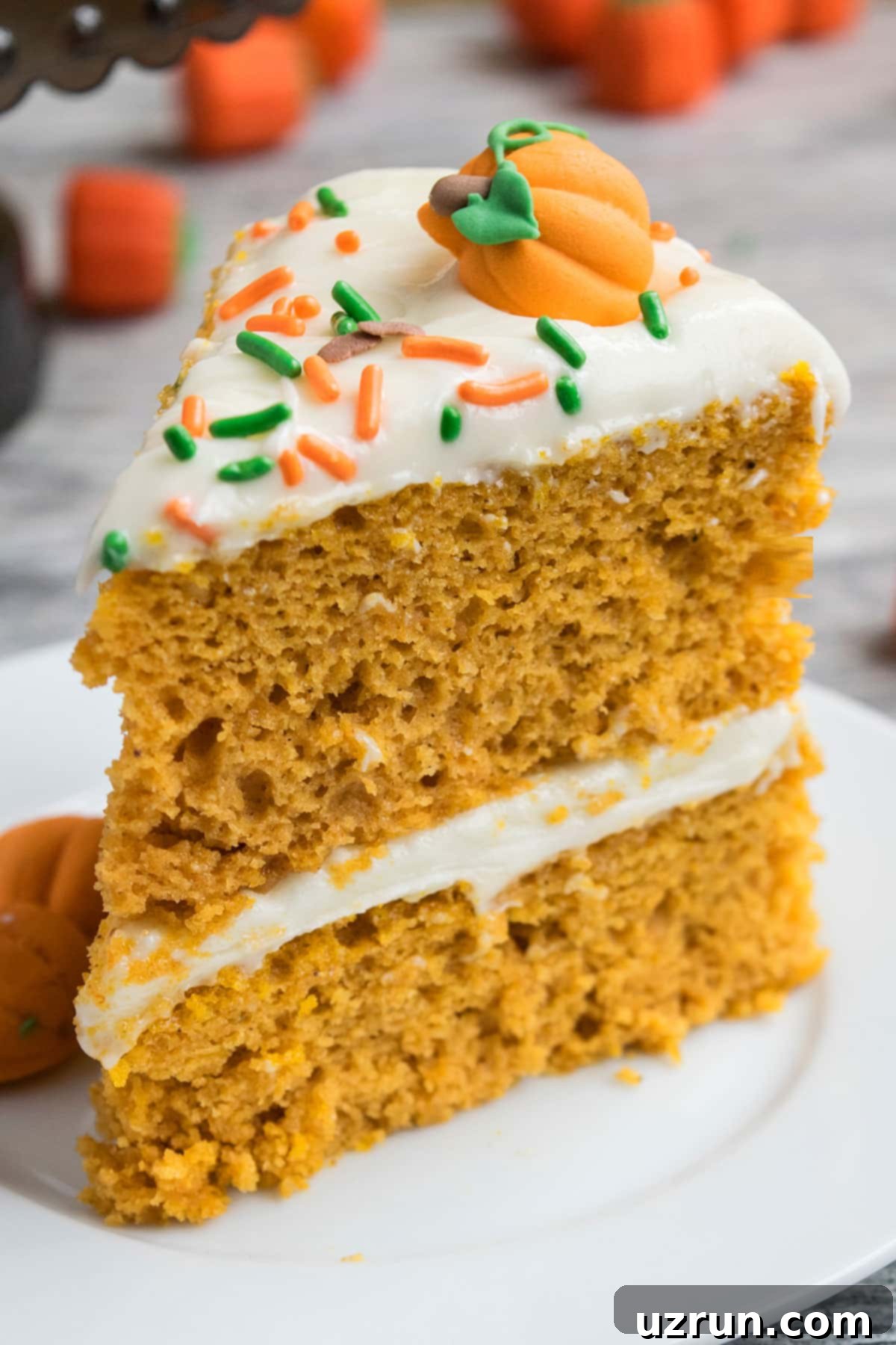 Slice of Easy Pumpkin Cake With Cake Mix Box and Cream Cheese Frosting.