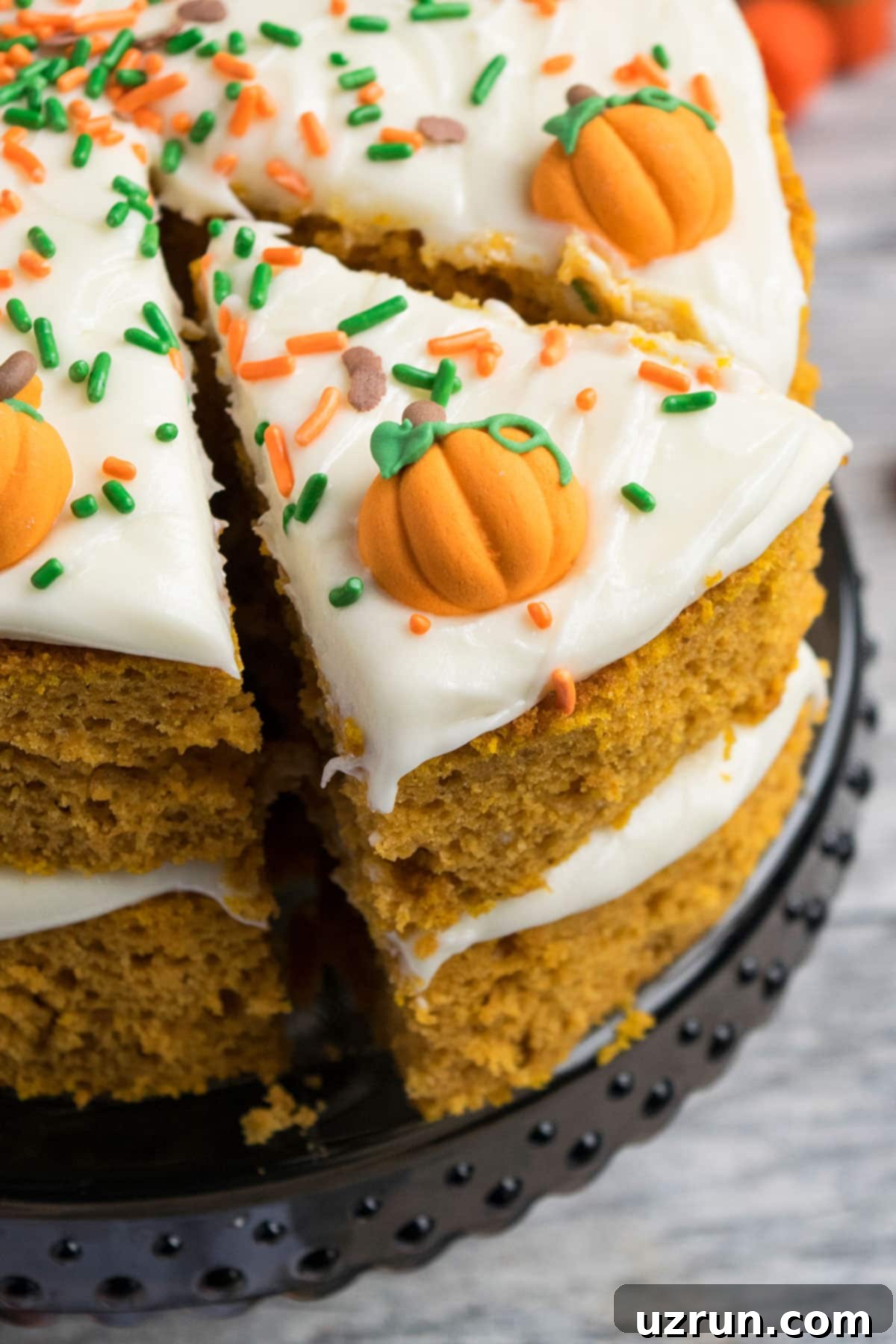 Simple Cake Mix Pumpkin Cake 3 Closeup Shot of Sliced Cake on Black Cake Stand.