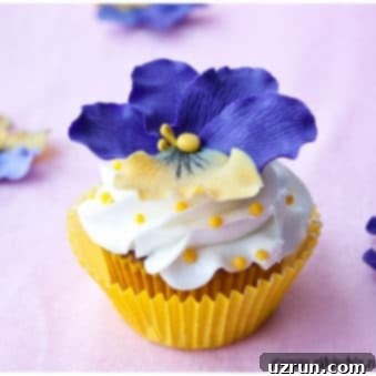 Easy Fondant Pansy Cupcakes 5 Easy Homemade Fondant Flower Cupcakes with Yellow Liner and Pink Background, featuring detailed pansy toppers