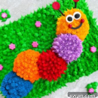 Easy Caterpillar Cake With Buttercream Icing on Light Gray Cake Board.
