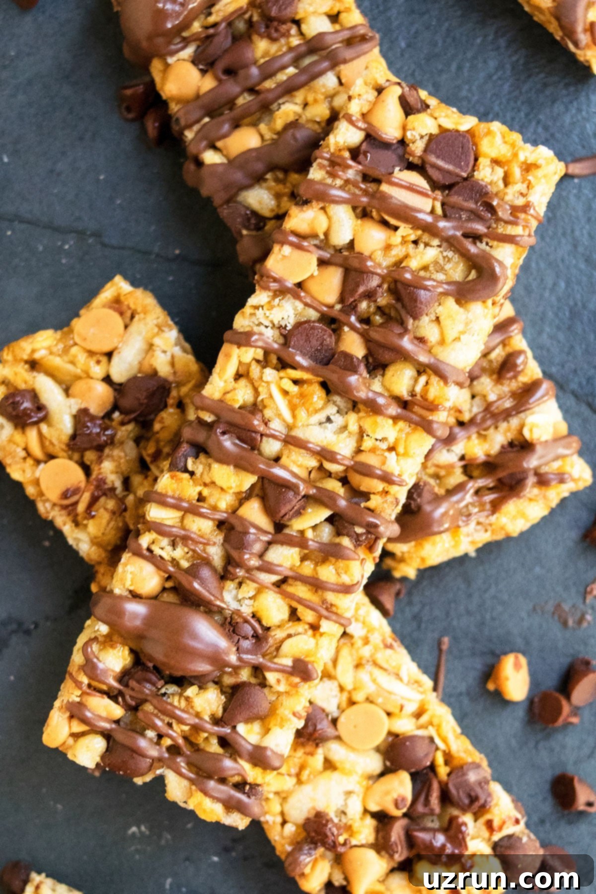 Easy No Bake Chewy Homemade Granola Bars With Peanut Butter and Chocolate Chips on Dark Gray Background.