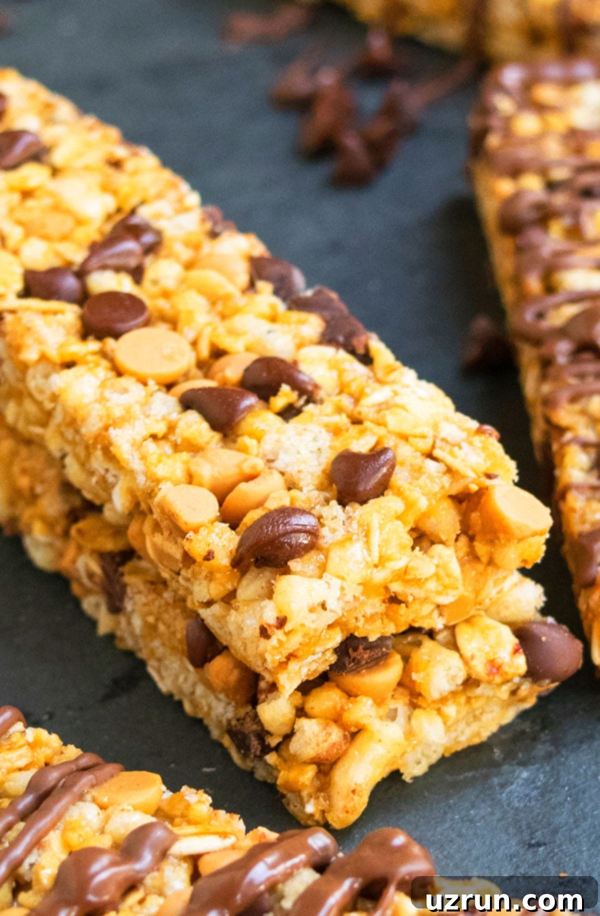 Effortless No Bake Granola Bars 3 Stack of Healthy Peanut Butter Oat Bars on Dark Gray Background.