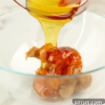 Effortless No Bake Granola Bars 4 Glass bowl with honey and peanut butter.
