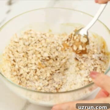 Effortless No Bake Granola Bars 6 Dry ingredients added to the wet ingredients.