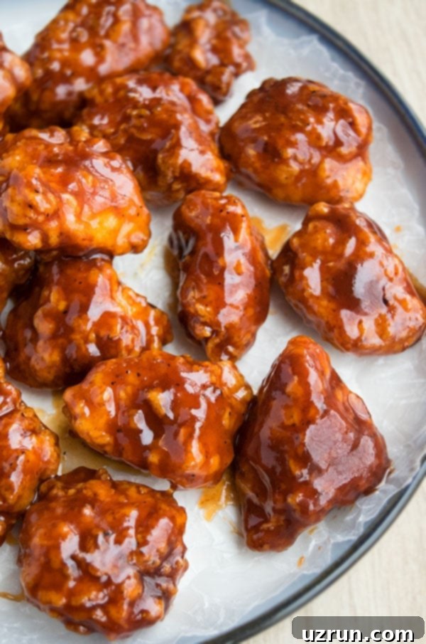Easy Sticky Honey BBQ Chicken Bites on White Dish.