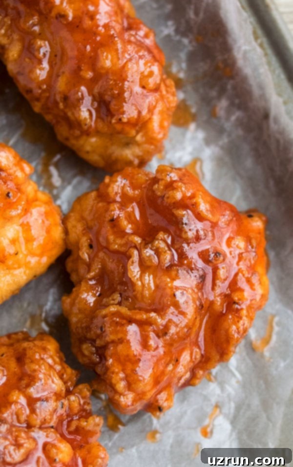 Closeup Shot of Spicy Chicken Bites on Sheet of Wax Paper. 