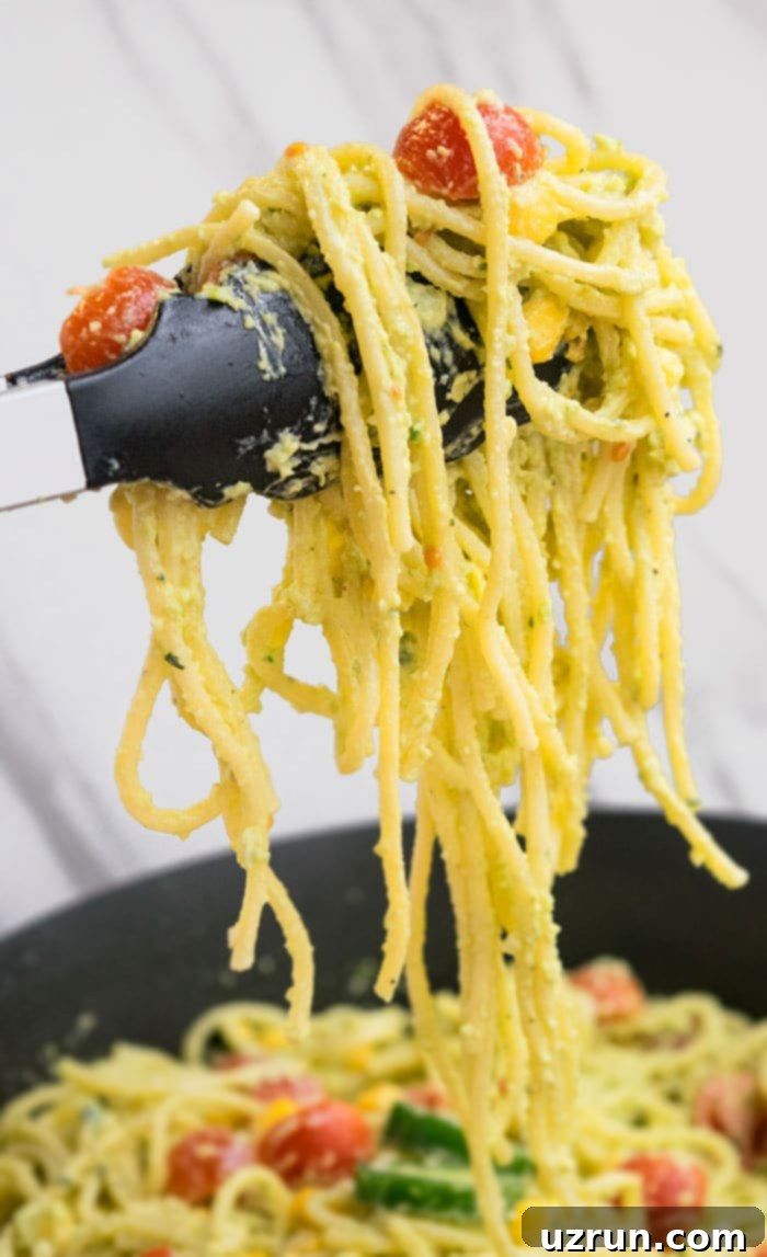 Spatula Holding Avocado Pasta Over the Pot. 