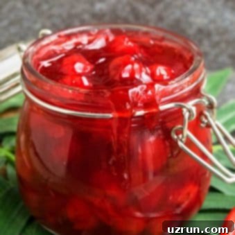 Easy Homemade Cherry Pie Filling Fresh or Frozen 5 Easy Cherry Pie Filling From Scratch in Glass Jar on Green Leaf.