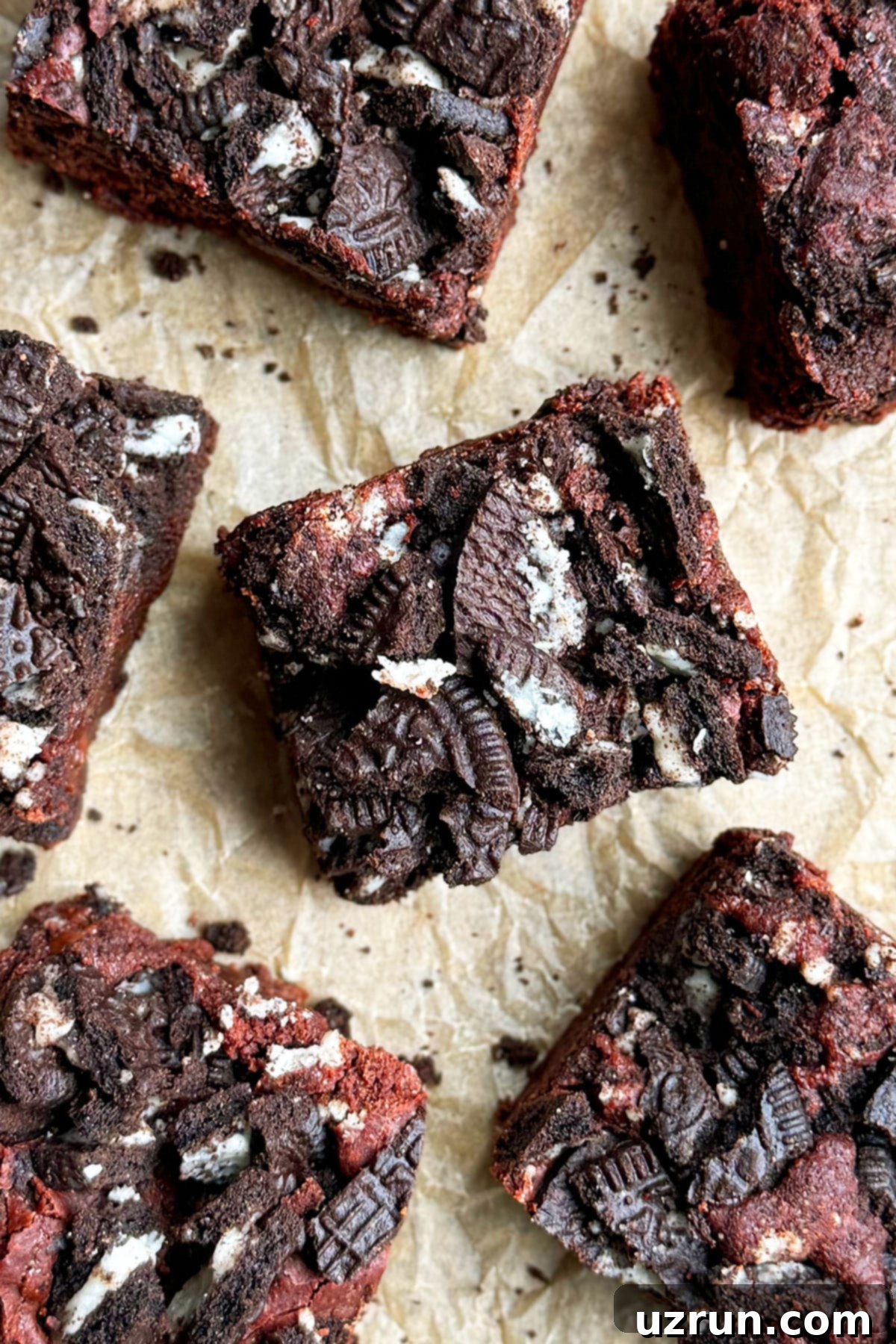 Easy Fudgy Oreo Brownies 13 Overhead shot of perfectly sliced fudgy chocolate Oreo brownies on brown parchment paper.