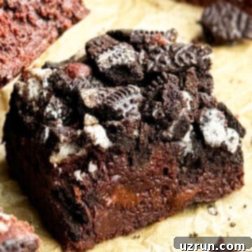 Easy Fudgy Oreo Brownies 14 Slice of Easy Fudgy Chocolate Oreo Brownies on Brown Parchment Paper.