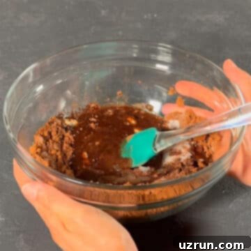 Easy Fudgy Oreo Brownies 4 Large glass bowl with melted chocolate mixture, smooth and glossy.
