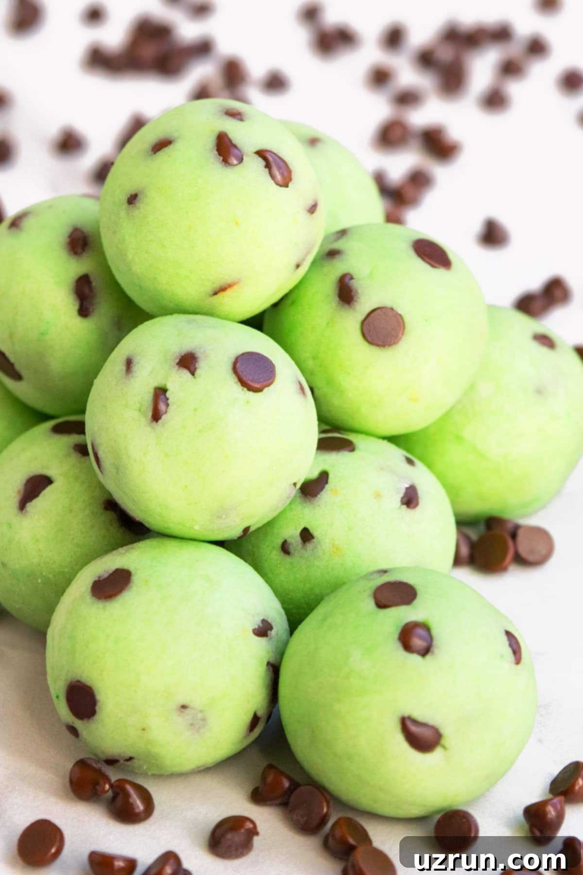 Stack of Easy Chocolate Mint Truffles With Chocolate Chips on White Background.