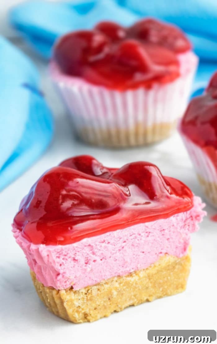 Mini Strawberry Cheesecake Cupcakes 3 Partially Eaten No Bake Dessert on White Dish.