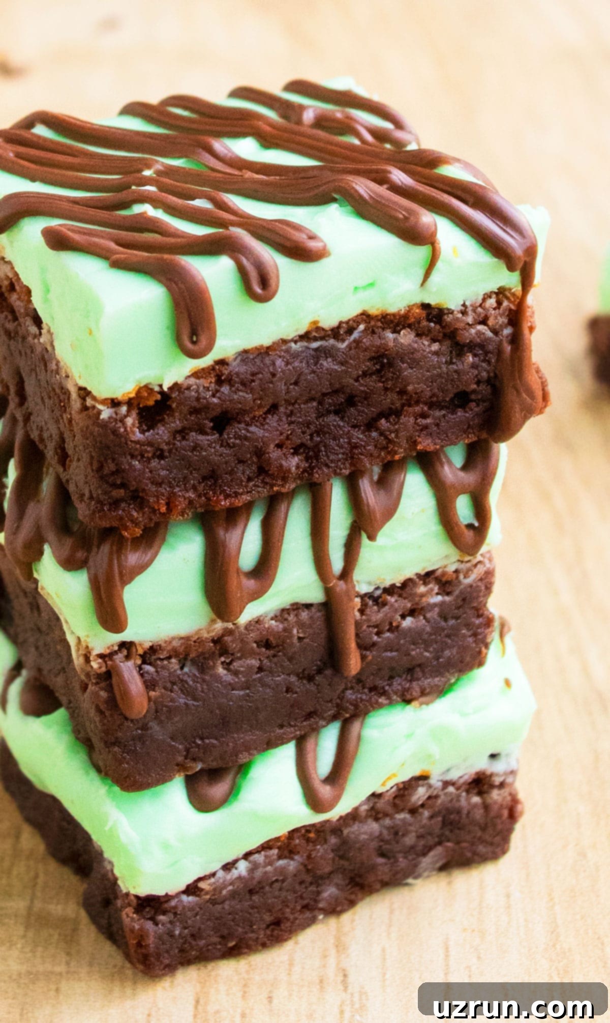 Stack of Chocolate Mint Brownies With Mint Buttercream Frosting on Wood Background. 