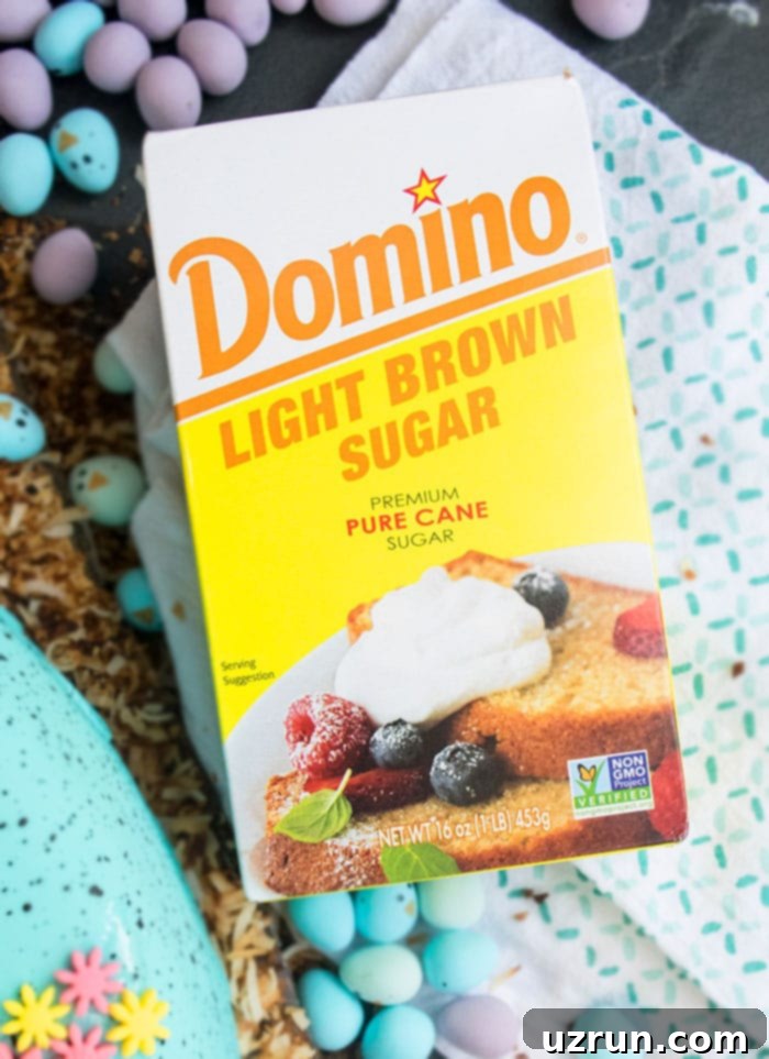 Surprise Inside Easter Robin Egg Cake 4 Box of Domino Sugar With Candies Scattered in the Background.