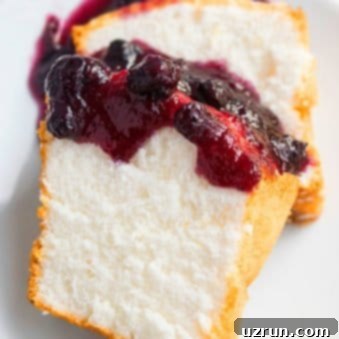 Fluffy Homemade Angel Food Cake 5 Slices of Angel Food Cake With Berry Topping on White Dish.
