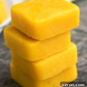 Simple Two-Ingredient Lemon Fudge 5 Stack of Easy 2 Ingredient Microwave Lemon Fudge on Rustic Gray Background.