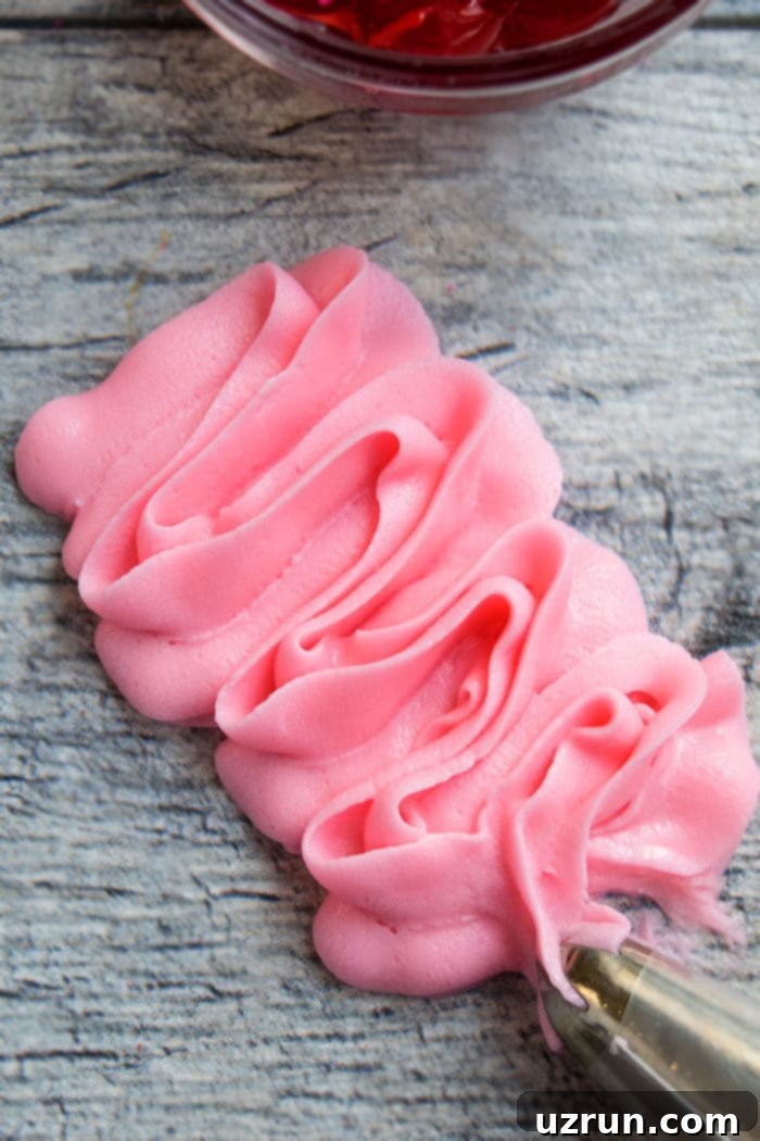 Pretty Pink Maraschino Cherry Frosting 6 Easy Homemade Pink Frosting Piped on Gray Background.