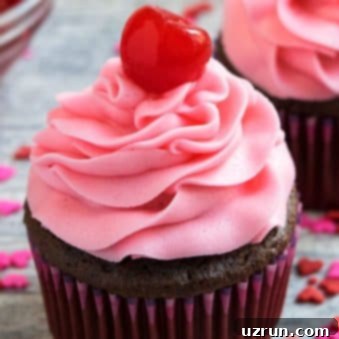 Pretty Pink Maraschino Cherry Frosting 7 Easy Maraschino Cherry Frosting (Buttercream Icing) Piped on Top of Chocolate Cupcake on Rustic Gray Background.
